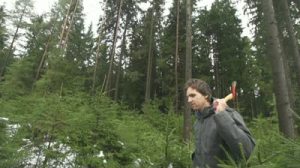 stock-footage-slow-motion-man-with-an-axe-walking-in-forest